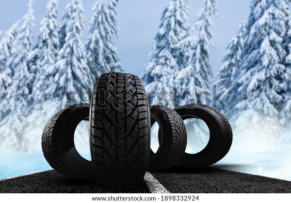 four winter tires on\
a winter background
