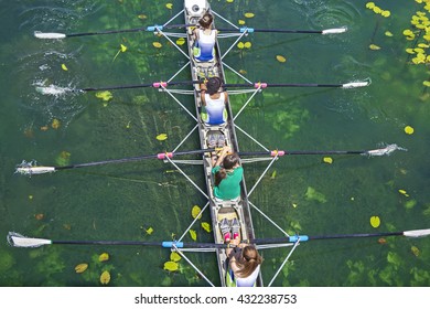 Four Women Rowing On The Tranquil Lake