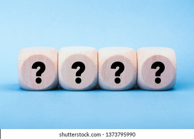 Four wooden blocks with black question marks. - Shutterstock ID 1373795990