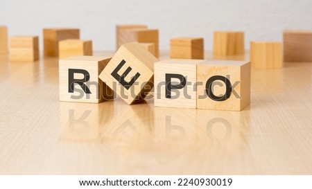 four wooden blocks with text REPO on table. copy space. white background.