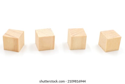 Four wooden geometric cube blocks flying on different sides, isolated on white background. toys for toddlers