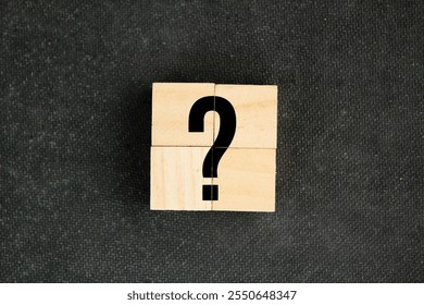 four wooden squares with big question mark symbols. the concept of a question or problem. Q and A. human resources concept