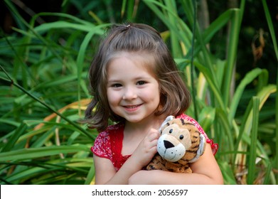 Four year old girl posing with her tiger.