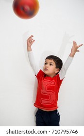 A Four Year Old Indian Kid Throwing Up A Ball