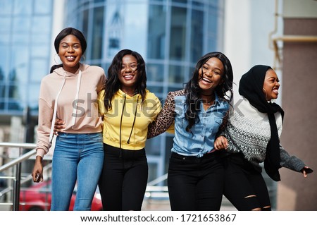 Four young college african american woman friends spend time together.