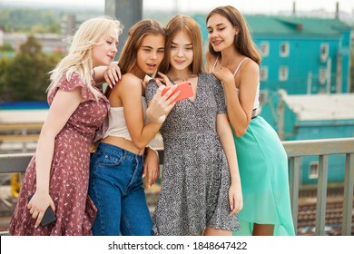 Four young girlfriends take a selfie on a smartphone