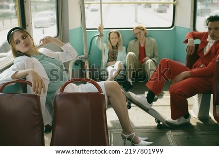 Tired women friends sleeping in a rear seat car