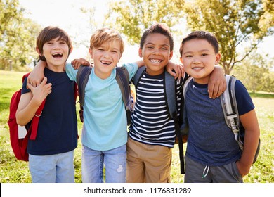 Four Young Smiling Schoolboys Hanging Out On A School Trip