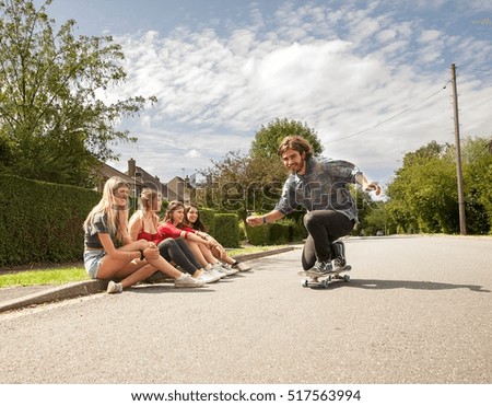 Similar – Happy young woman riding on skate with her friends