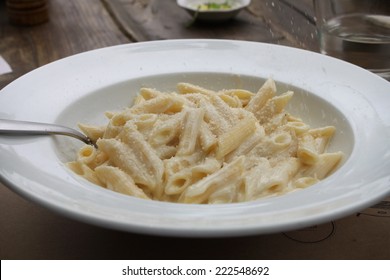 A Four-cheese Pasta Platter With Cheese Being Drizzled On It.