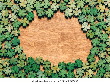 Four-leaf Clovers Laying On Wooden Floor, Creating A Circle. Irish Culture. St. Patrick's Day.