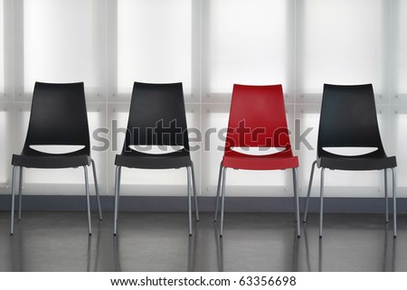 Fours chairs in line against wall