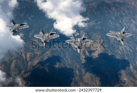 A four-ship formation of U.S. Air Force F-22 Raptors f from the 94th Fighter Squadron and 1st Fighter Wing  fly in formation over the Rocky Mountain Range in Colo.
