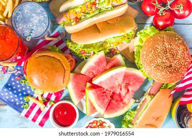 Fourth Of July, Memorial Day, USA Independence Day Concept. Patriotic, American Traditional Food. Picnic Party With Watermelon, Burgers, Hot Dogs, Drinks, Blue Wooden Outdoor Table Background