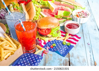 Fourth Of July, Memorial Day, USA Independence Day Concept. Patriotic, American Traditional Food. Picnic Party With Watermelon, Burgers, Hot Dogs, Drinks, Blue Wooden Outdoor Table Background