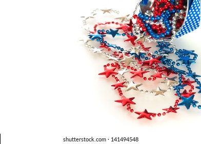 Fourth Of July Red, White, And Blue Beads In Star Shapes Flowing Out Of A Little Bucket On White, Reflective Background With Room Or Space For Your Words Or Text