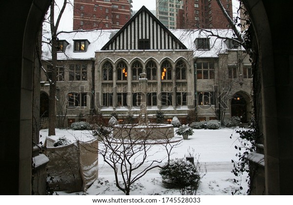 Fourth Presbyterian Church entrance with\
falling white snow in winter in Chicago, IL, USA. Antique\
architecture located in Chicago loop\
downtown.