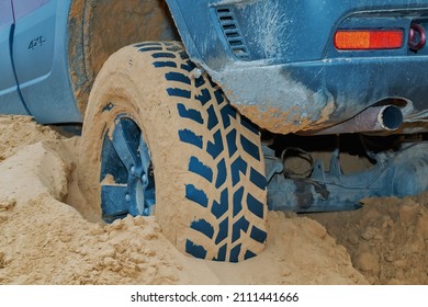 Four-wheel Drive Car Stuck In The Sand. Close-up. 