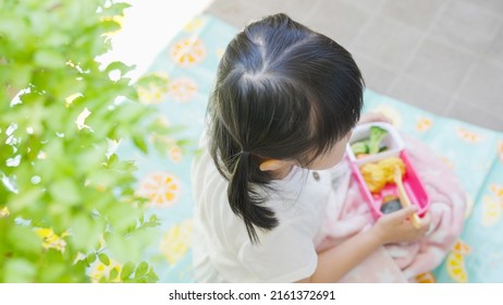 Four-year-old Child Eating Lunch Outside.