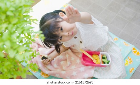 Four-year-old Child Eating Lunch Outside.