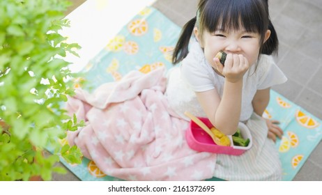 Four-year-old Child Eating Lunch Outside.