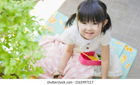 Four-year-old Child Eating Lunch Outside.