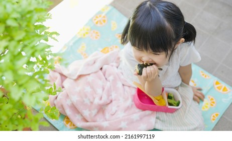 Four-year-old Child Eating Lunch Outside.