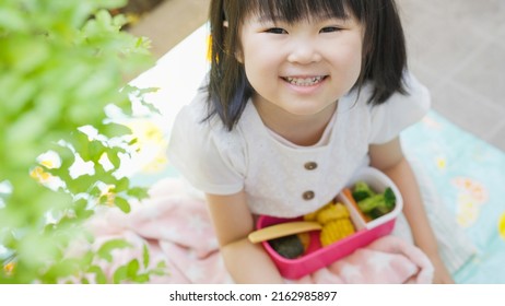 Four-year-old Child Eating Lunch Outside.