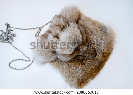 Fox fur and handbag with real fur displayed in a shop. a bag in the form of a muzzle of a fox
