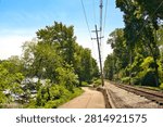 The Fox River Trail passes between the river and railroad tracks on a sunny summer day near South Elgin, IL.