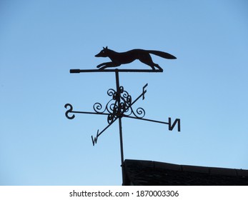 Fox Weather Vein Silhouetted Against Blue Sky