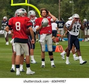 FOXBOROUGH, MA - AUGUST 6: Tom Brady has a break during a practice at the training camp in Foxborough MA. August 2010. Tom Brady is in the center of the image has his helmet ind right hand.