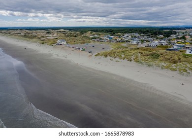 Foxton Beach, New Zealand, March 05 2020. An Aerial View Of Foxton Beach Surf Club And Carpark With The Sandy Beach In The Foreground And The Flat Manawatu Plains In The Midground