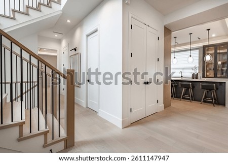foyer entry interior front door with glass dark wood staircase with wrought iron rails wooden hardwood floors modern spacious new construction family home interior welcome 