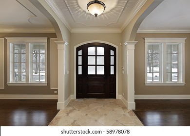 Foyer In New Construction Home With Mahogany Wood Door