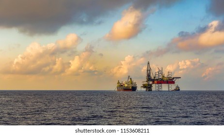 FPSO Ship And Drilling Rig In Offshore Oil Field With Beauty Cloud And Blue Sky Background