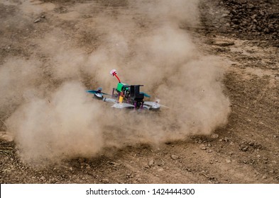 Fpv racer drone dusty landing