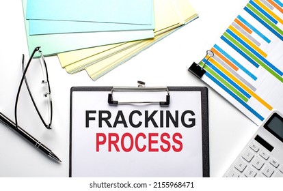 FRACKING PROCESS text on a paper sheet with chart,color paper and calculator
