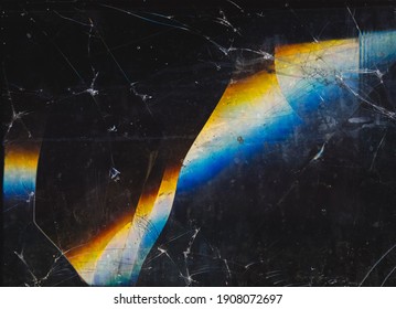 Fractured background. Blur lens flare. Dark shattered distressed dirty faded screen matrix texture with dust scratches smeared stains defocused orange blue white glow.