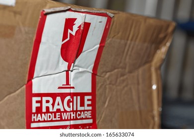 Fragile Handle With Care Sign On A Damaged Package