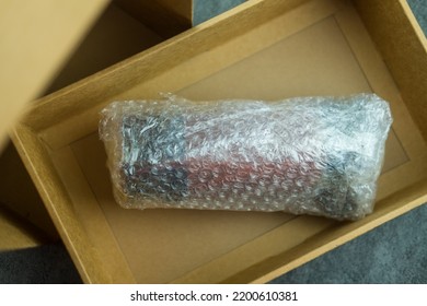 Fragile Item Wrapped In Bubble Wrap Put In A Brown Box