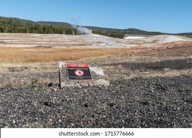 Fragile Thermal Area Prohibited Sign With Old Faithful Geyser In Background.