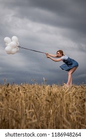 Fragile Woman Keeps Balloons Against Strong Wind