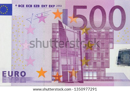 Fragment of a 500 euro banknote close up, background.