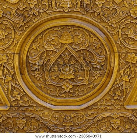 Fragment of an ancient carved wooden door. Ornate background.