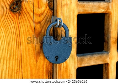 Fragment of ancient church door. Close-up of wooden door with metal rusty ring. Antique elements and details of urban architecture.