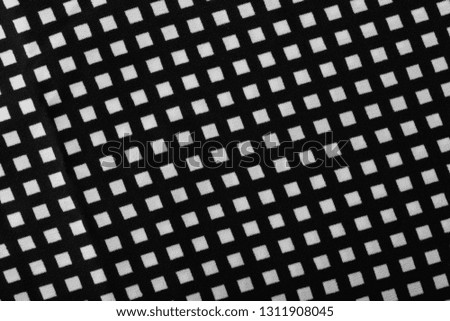 fragment of black cotton fabric with waves