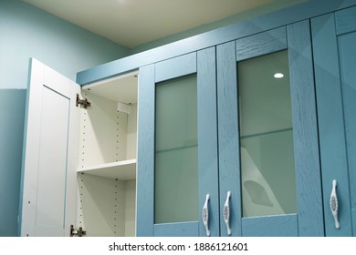 A Fragment Of A Blue Kitchen Set With An Open Door. Cropped Frame. Close-up