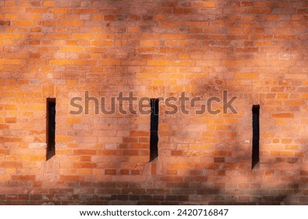 Fragment of a brick wall surrounding a military fortress from tsarist times, loopholes