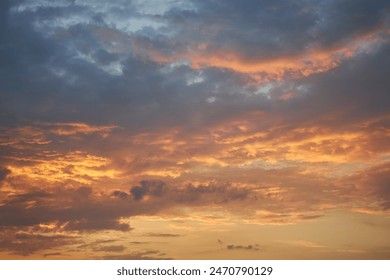 A fragment of a bright sunset sky with bizarrely shaped clouds. Captivating dusk sky displaying a palette of warm hues, perfect for your design projects. - Powered by Shutterstock